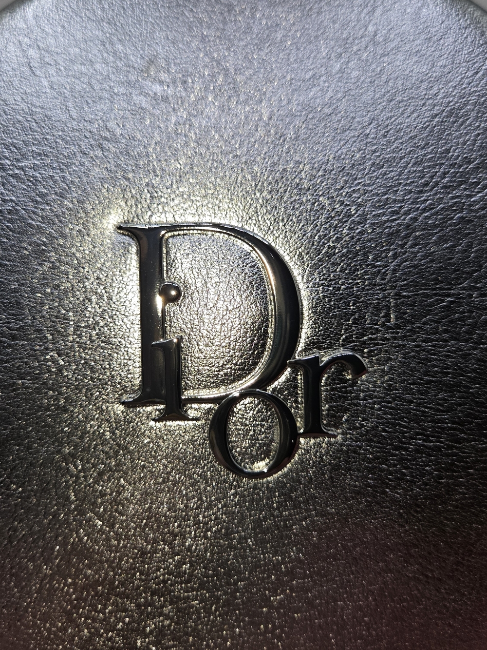 Round cosmetic pouch in metallic silver finish featuring raised logo - Picture 2 of 6